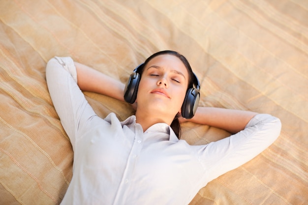 Happy young woman listening to music