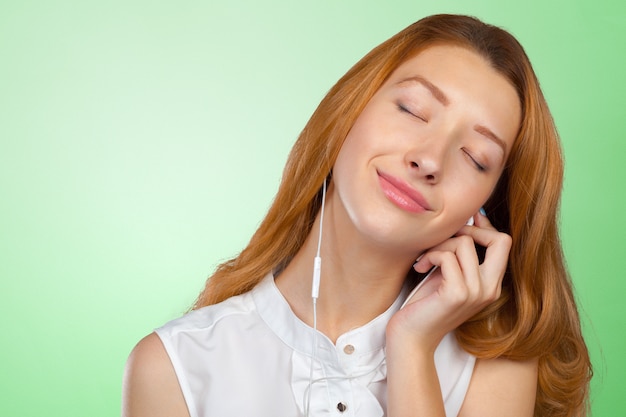 Happy young woman listening to music