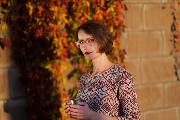 Happy young woman in park on sunny autumn day