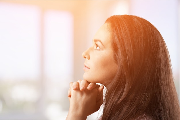 Happy Young Woman Praying holding hands together