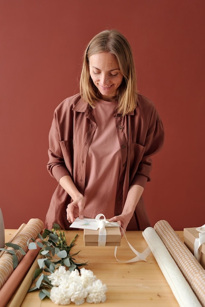 Happy young woman preparing presents