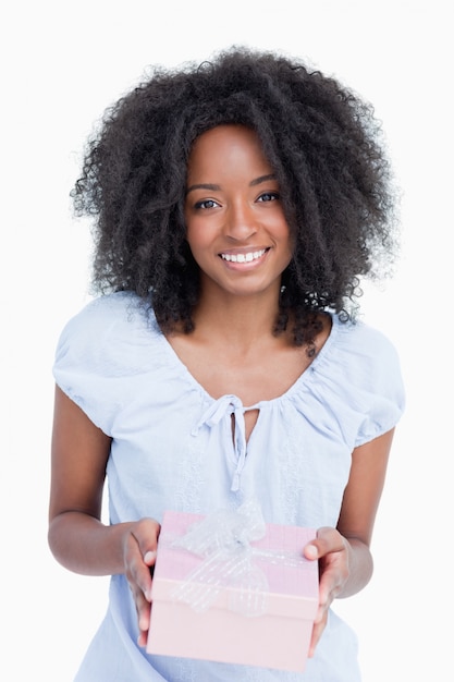 Happy young woman receiving a birthday gift