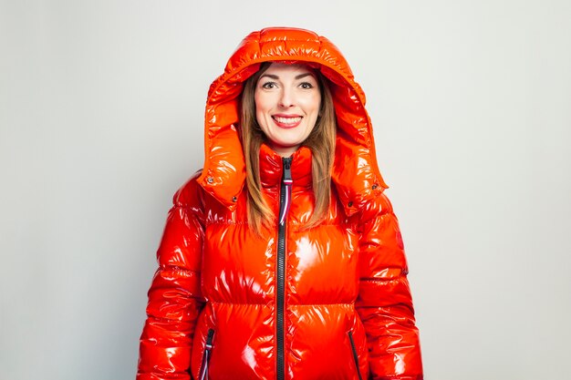 Happy young woman in a red jacket isolated