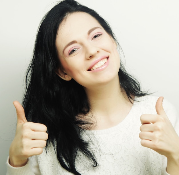 Happy Young Woman Showing Thumb Up