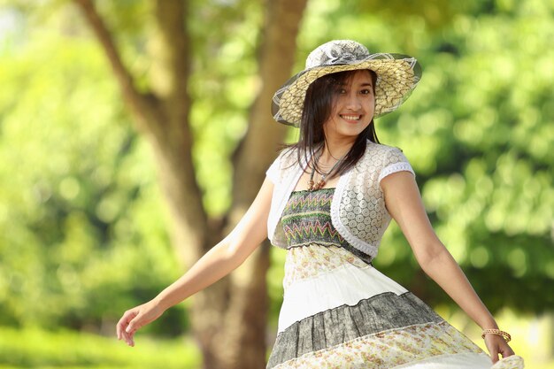 Happy young woman smiling in a park