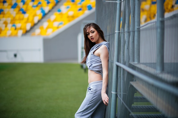 Happy young woman on stadium