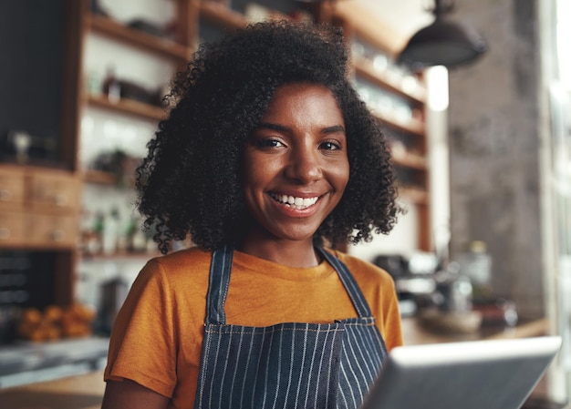happy young woman standing in her cafe