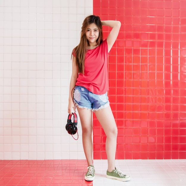 Happy Young Woman Standing with Headphone