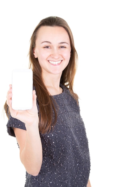 Happy young woman in sweater showing blank smartphone screen