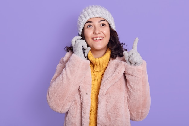 Happy young woman talking on mobile phone, having excited facial expression