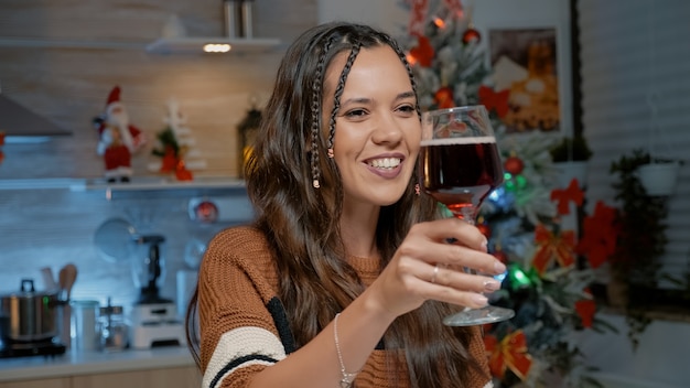 Happy young woman talking on video call at home