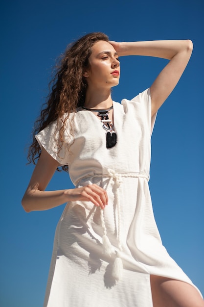 Happy young woman on tropical resort. Fashion style woman. Concept of enjoying weekend, vacation