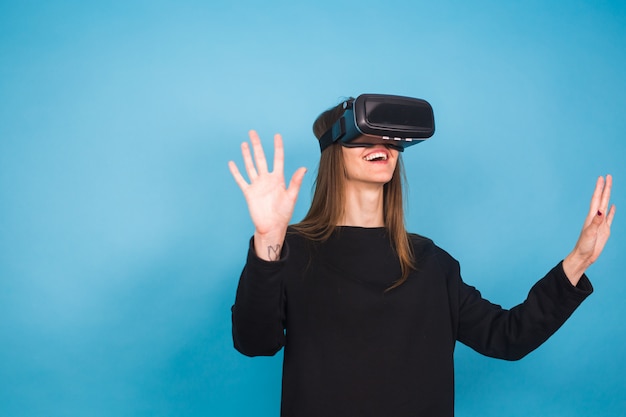 Happy young woman using a virtual reality headset.