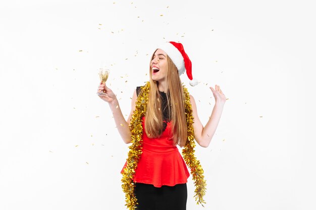 Happy young woman wearing a dress and Santa hat