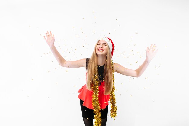 Happy young woman wearing a dress and Santa hat