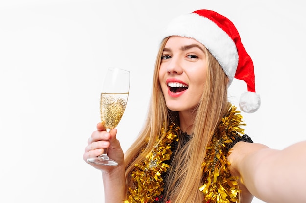 Happy young woman wearing a dress and Santa hat