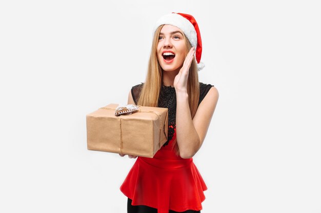 Happy young woman wearing a dress and Santa hat