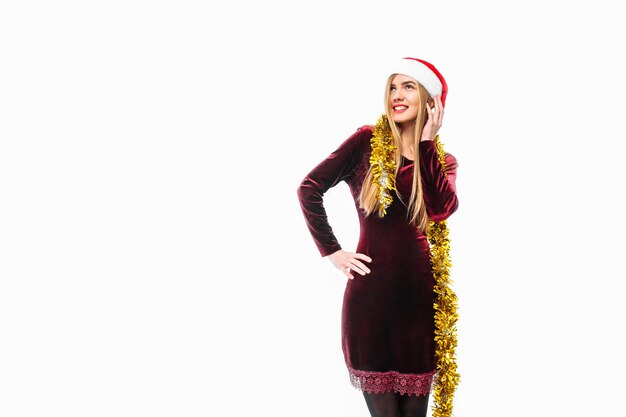 Happy young woman wearing a dress and Santa hat