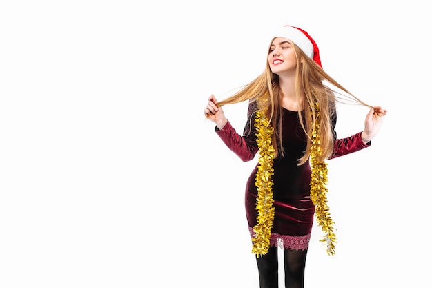 Happy young woman wearing a dress and Santa hat