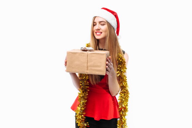 Happy young woman wearing a dress and Santa hat