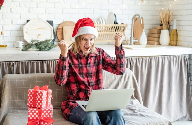 Happy young woman wearing Santa hat