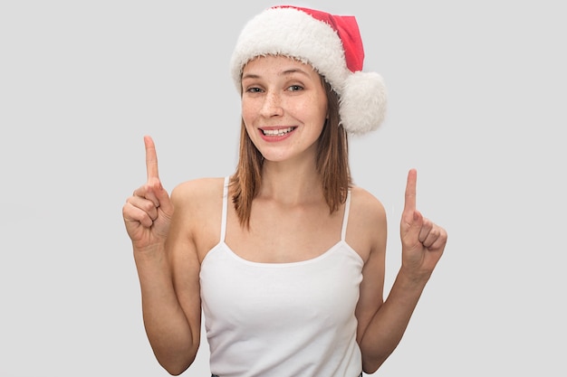 행복 한 젊은 여자는 크리스마스 모자를 착용