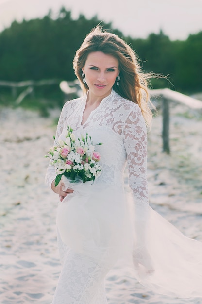 Happy young woman in wedding dress