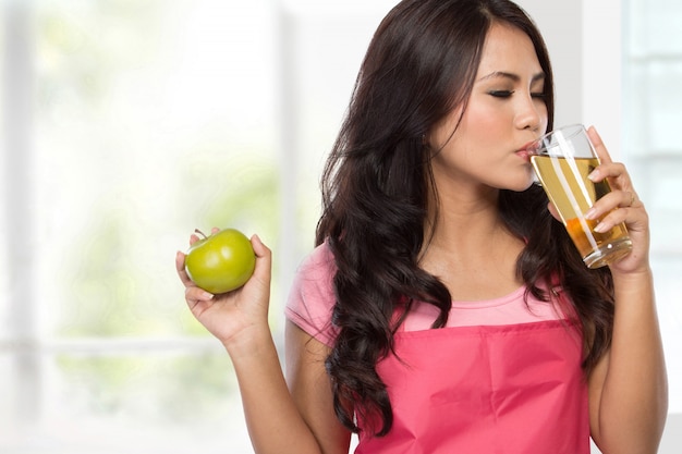 Happy young woman with apple juice