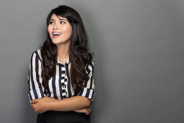 Happy young woman in work suit, smiles