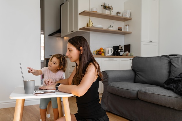 Happy young woman working from home with child. Home office. Quarantine