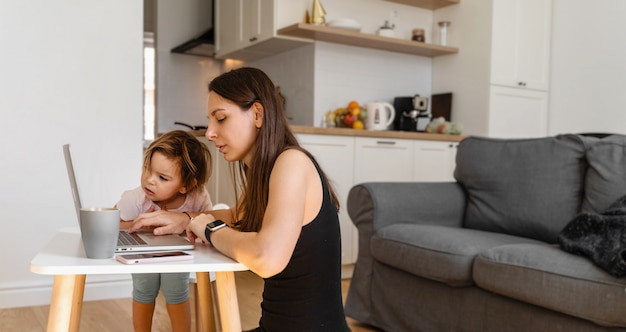 Happy young woman working from home with child. Home office. Quarantine