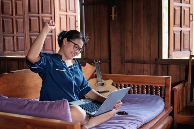 A happy young woman working online