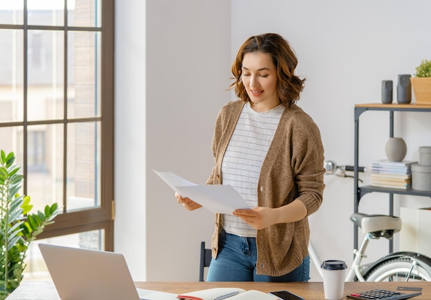 Happy young woman working watching webinar podcast on laptop having remote conversation