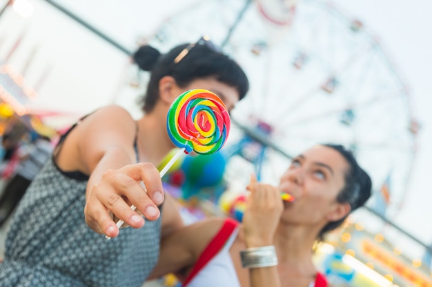 Happy Young Women eating Lollipop