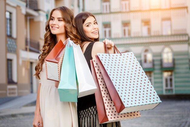 Happy young women with shopping bags