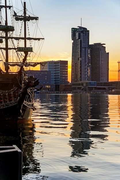 Harbor pier with ship and tower building