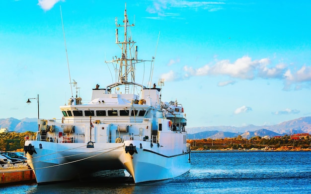 Harbor with ferry ship at Mediterranean Sea in Old city of Olbia on Sardinia Island in Italy. Yacht on Italian coast of Sardegna. Mixed media.