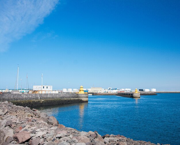 Harbour edge on edge of capital city port in the distance