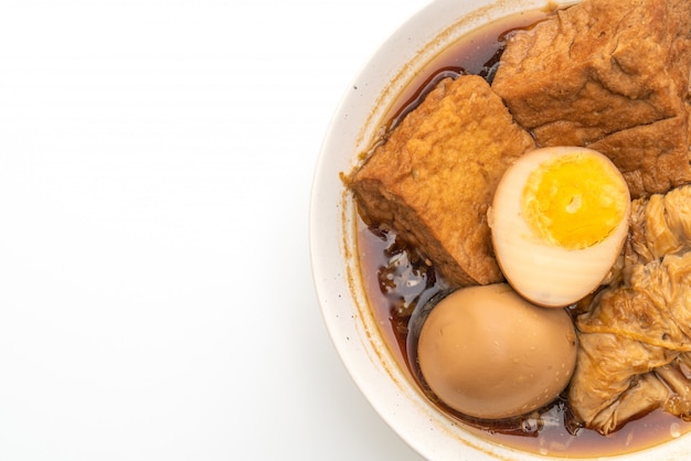 hard-boiled egg in brown sauce or sweet gravy isolated on white 