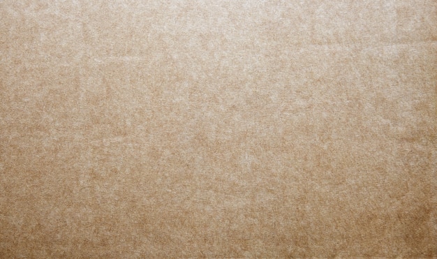 Фото Жесткая коричневая крафт-бумага фон с текстурами