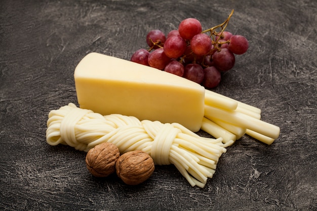 Hard cheese and pigtail, decorated with walnuts and grapes