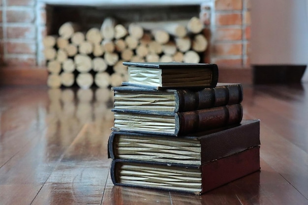 Hard cover books on the wooden floor in winter house. Education and book's day concept.