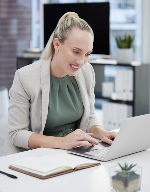 A hard day of work is rewarding Shot of a young businesswoman working at her desk using her laptop