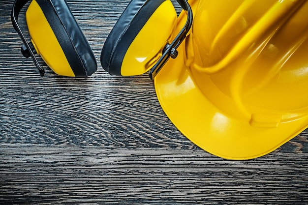 Hard hat earmuffs on wooden board