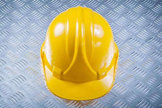 Hard hat on fluted metal background construction concept