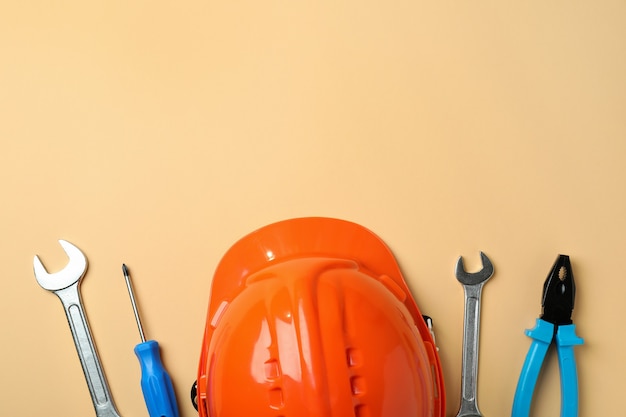 Hard hat and tools on beige