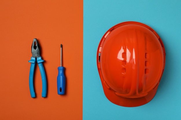 Hard hat and tools on two tone, top view