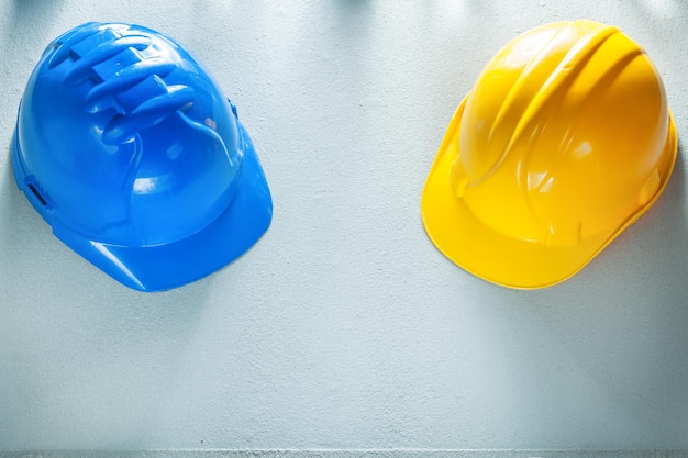 Hard hats on concrete background