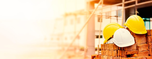 hard hats of construction engineers and workers on piles of bricks at construction site