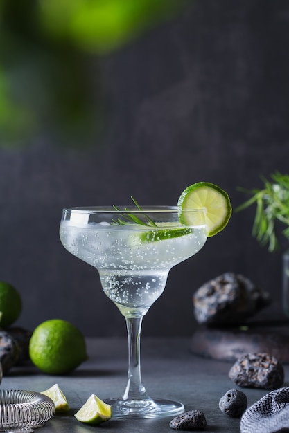 Hard seltzer cocktail with lime rosemary and bartenders accessories